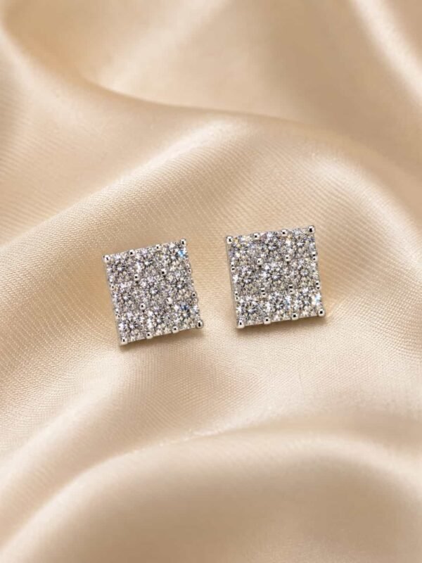 Lustre Grid square sparkle stud earrings displayed on champagne satin