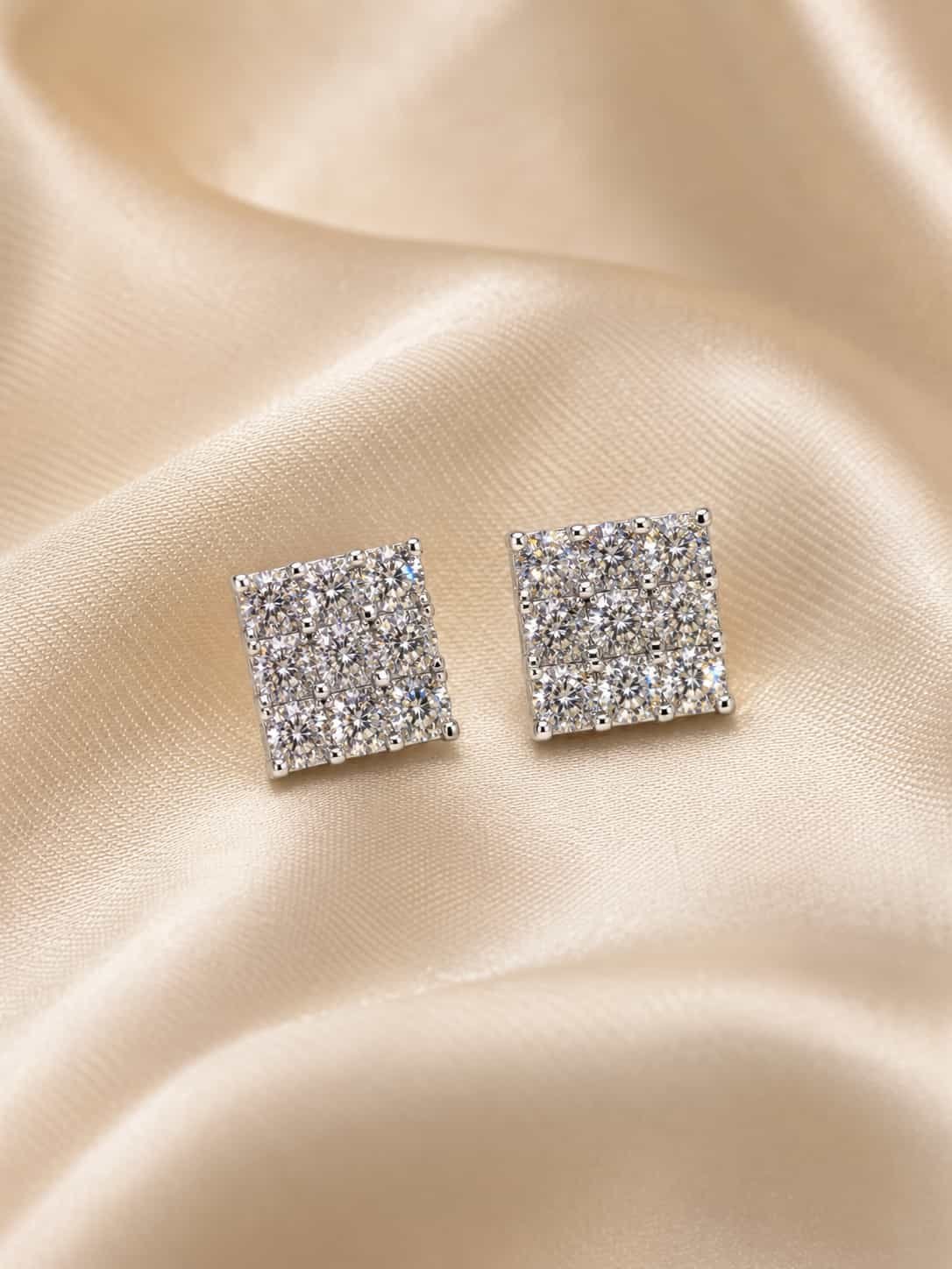 Lustre Grid square sparkle stud earrings displayed on champagne satin