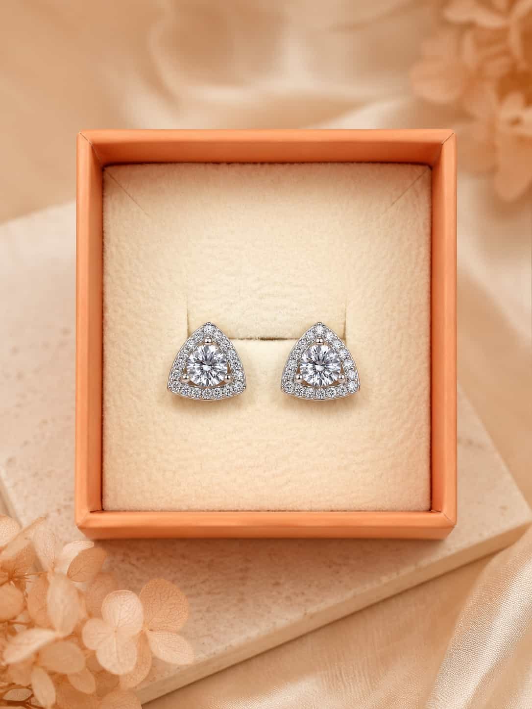 Celeste platinum polished triangle halo stud earrings presented in jewellery gift box
