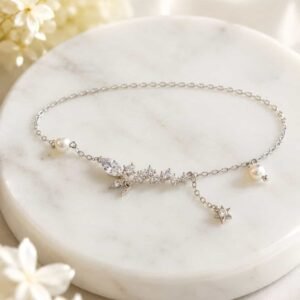 Celestia butterfly pearl bracelet with sparkling stones and star charm displayed on white marble