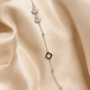 Noir Belle silver-tone butterfly bracelet with sparkling butterfly motifs and black clover accent on champagne satin