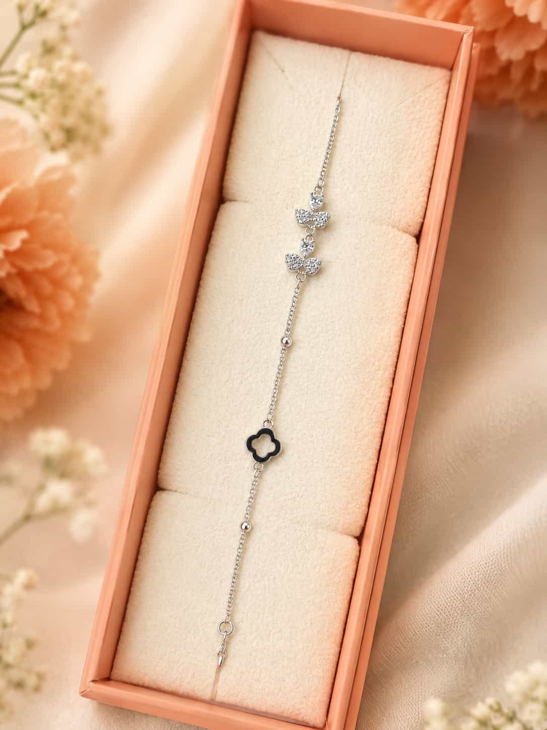 Noir Belle butterfly and black clover bracelet presented in an elegant jewellery gift box