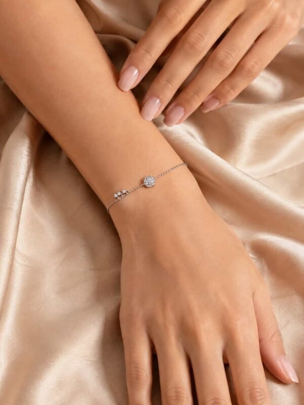 Woman wearing Celeste Halo Trio Sparkle Bracelet with delicate round halo design