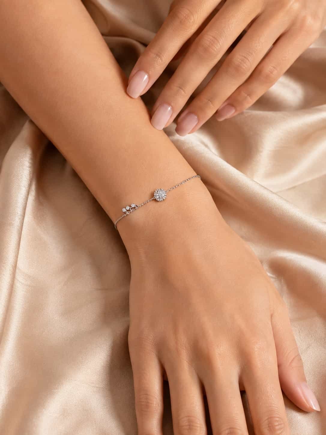 Woman wearing Celeste Halo Trio Sparkle Bracelet with delicate round halo design