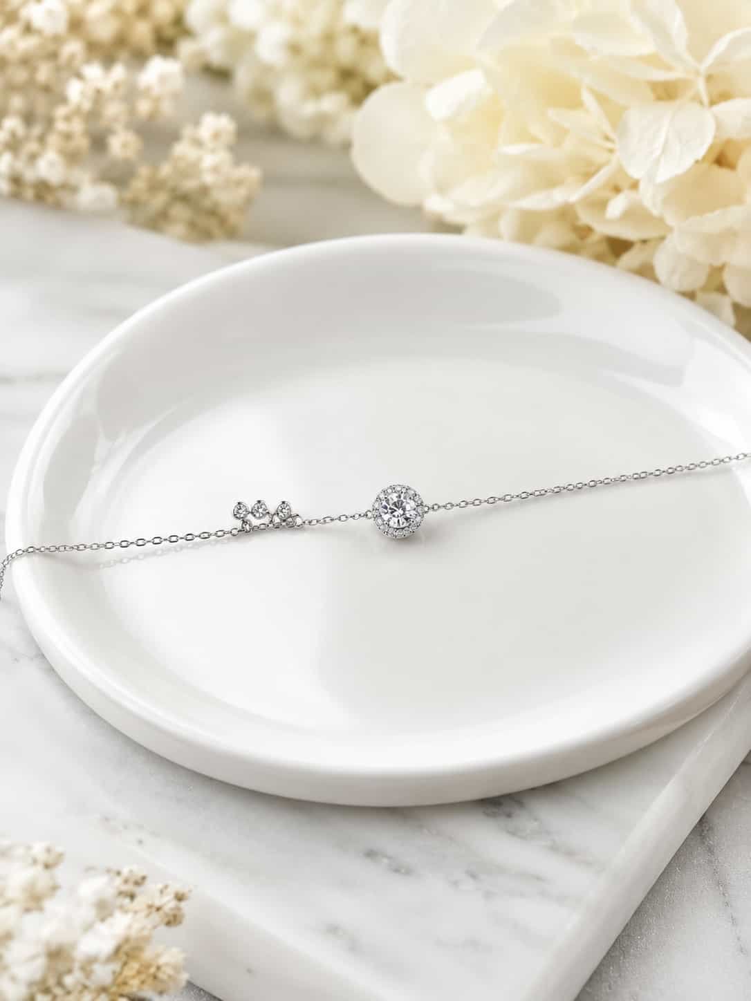 Celeste Halo Trio Sparkle Bracelet with round centre halo displayed on white jewellery dish