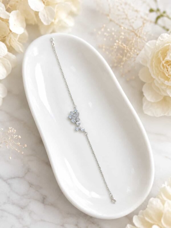 Delicate crystal flower vine bracelet for women displayed on white ceramic tray