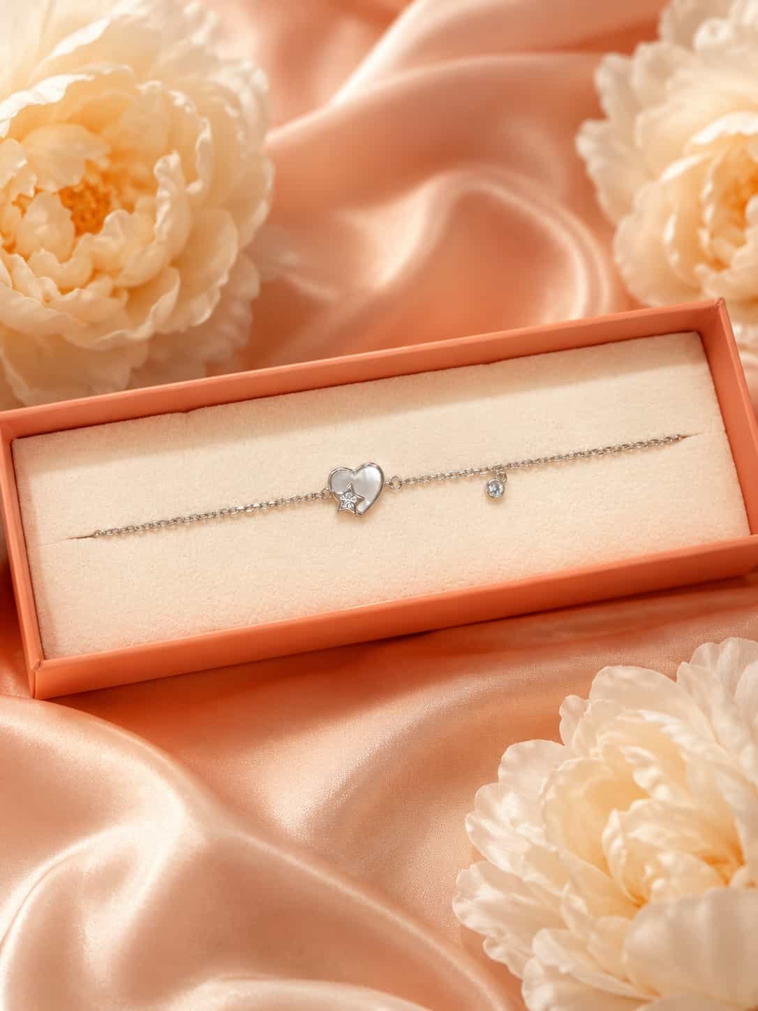 Celestia heart and star charm bracelet presented in an elegant jewellery gift box with soft floral styling