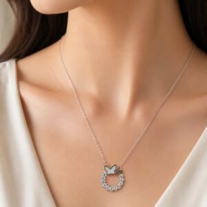 Woman wearing Lumière butterfly halo pendant necklace with delicate silver-tone chain